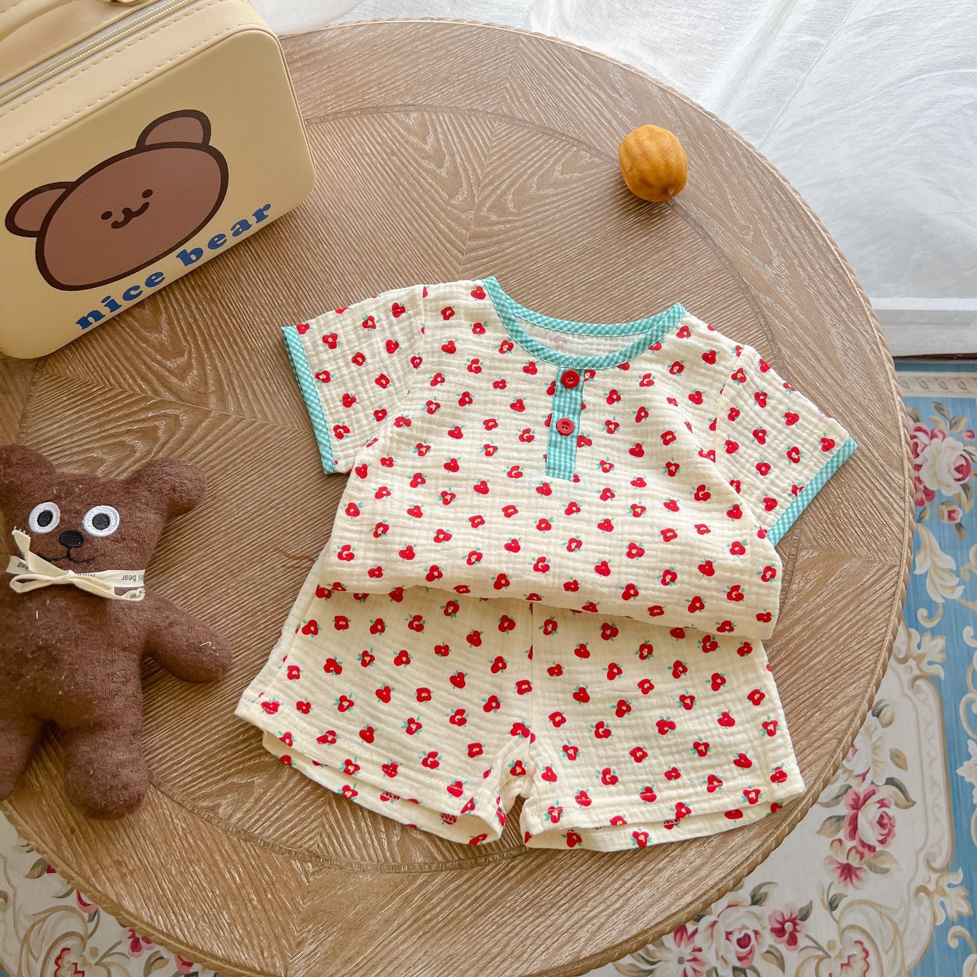 A colorful baby summer outfit featuring a print pattern t-shirt and combo shorts, perfect for keeping little ones cool and stylish.