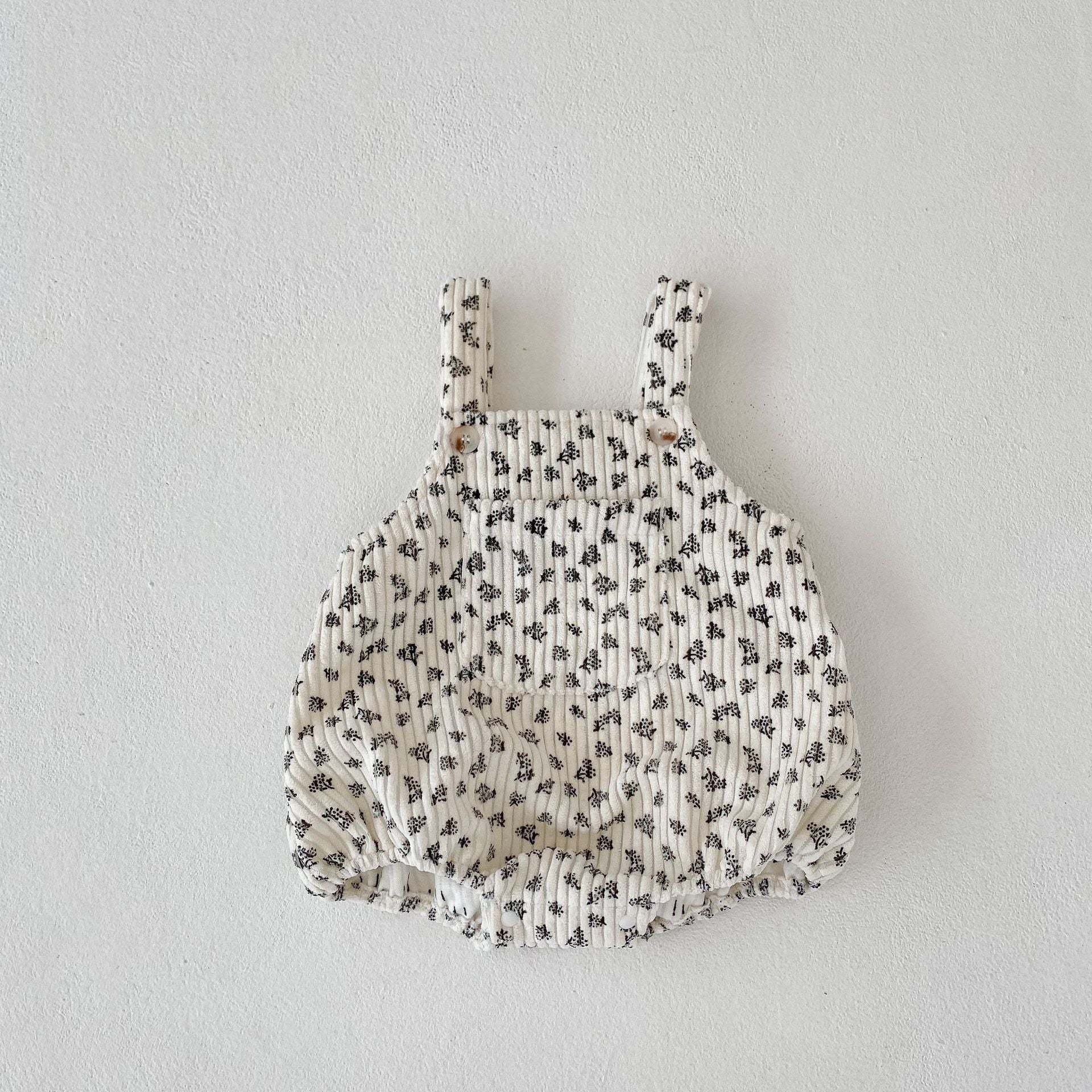 A collection of Baby Print Pattern Vintage Style Cute Strap Onesies in beige, apricot, and brown with floral, animal, and cartoon designs.