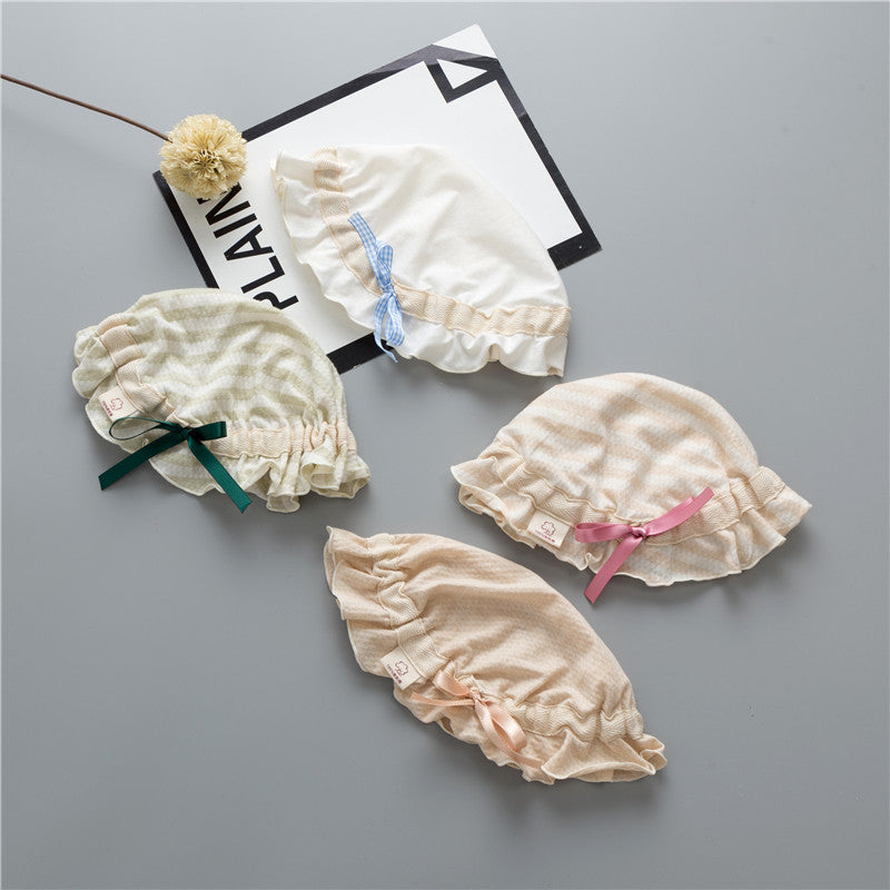 Adorable baby hats with ruffle design and bow decoration in various colors, perfect for stylish infants.