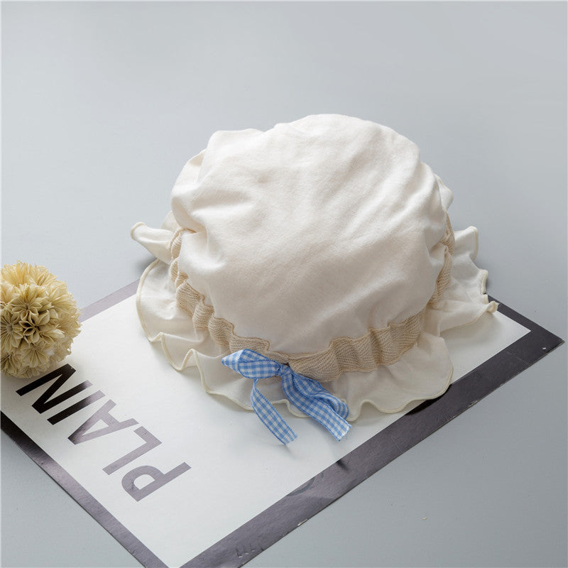 Adorable baby hats with ruffle design and bow decoration in various colors, perfect for stylish infants.