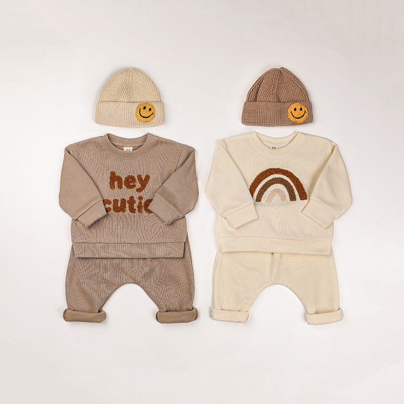 A cozy Baby Rainbow & Letter Graphic Hoodie and Pants Set in beige, featuring colorful rainbow and letter designs, perfect for babies.