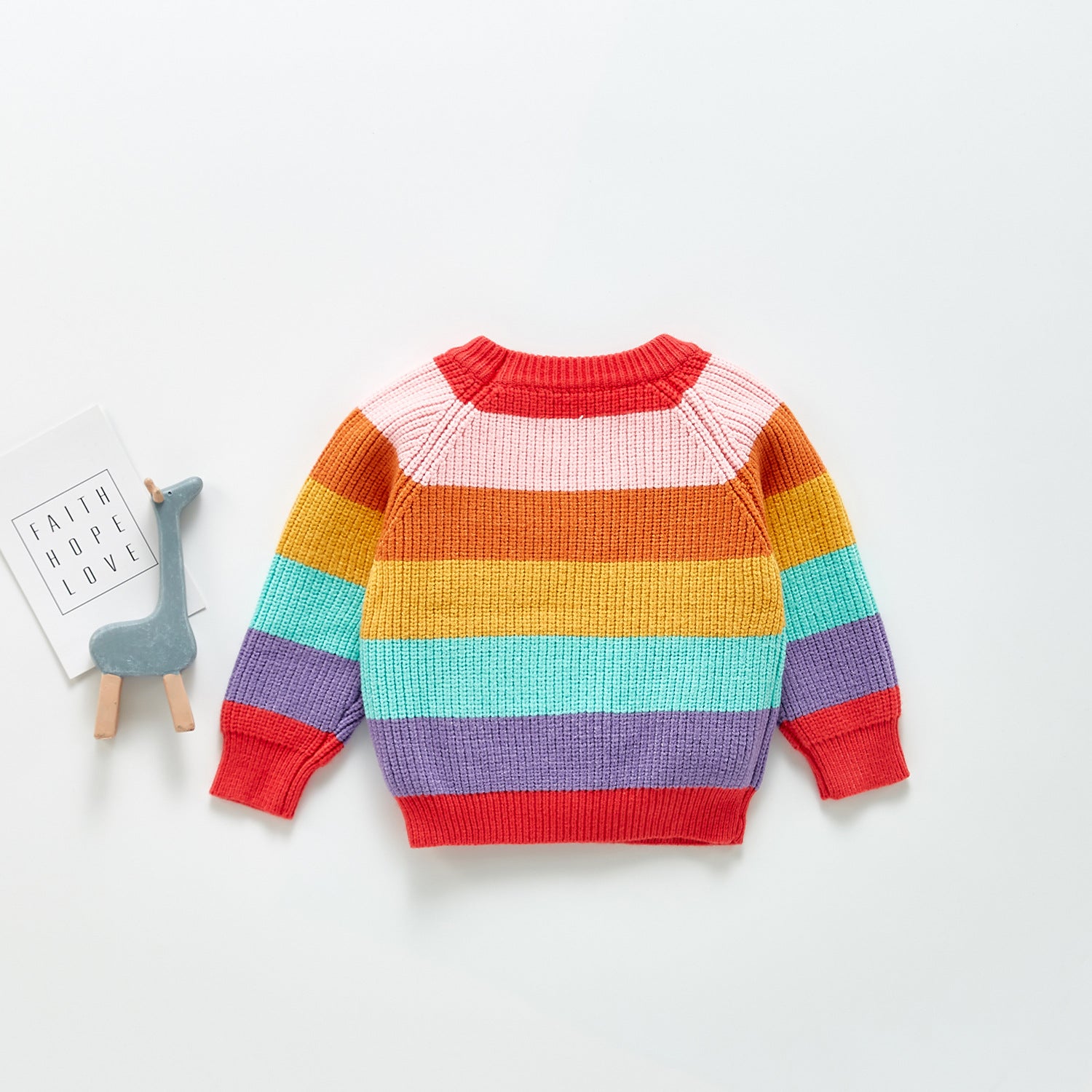 A colorful baby pullover sweater featuring a rainbow striped pattern, made from soft cotton, perfect for infants.