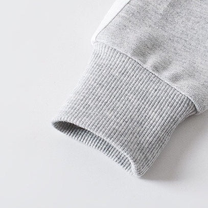 A cozy baby coat featuring a side striped pattern and zipper front design, perfect for winter wear, available in multiple colors.