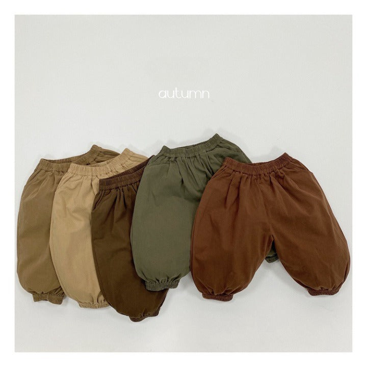 A pair of baby solid color pants in various colors, showcasing their loose and comfy design suitable for both boys and girls.