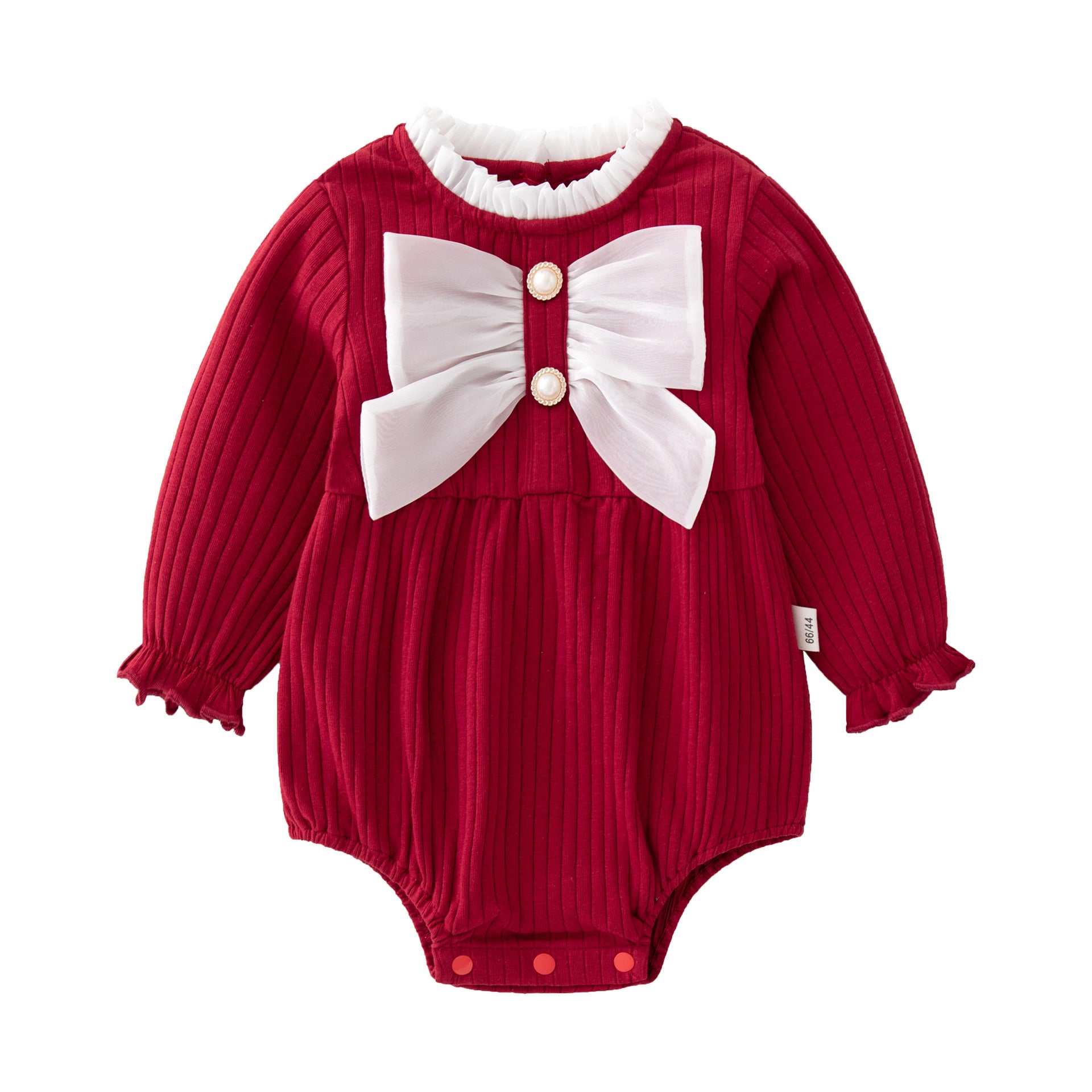 Baby girl wearing a solid color onesie with a big bow design, showcasing comfort and style.