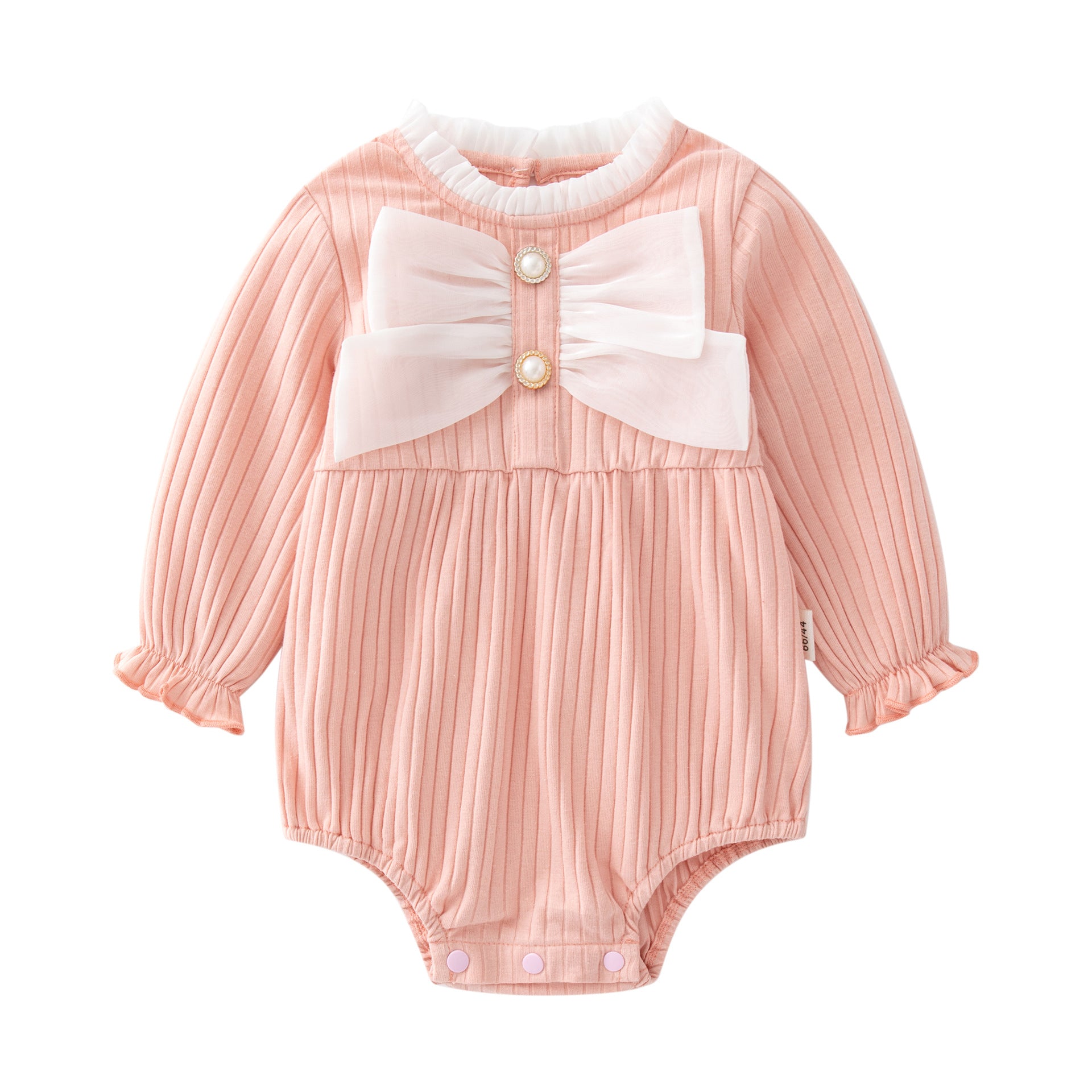 Baby girl wearing a solid color onesie with a big bow design, showcasing comfort and style.