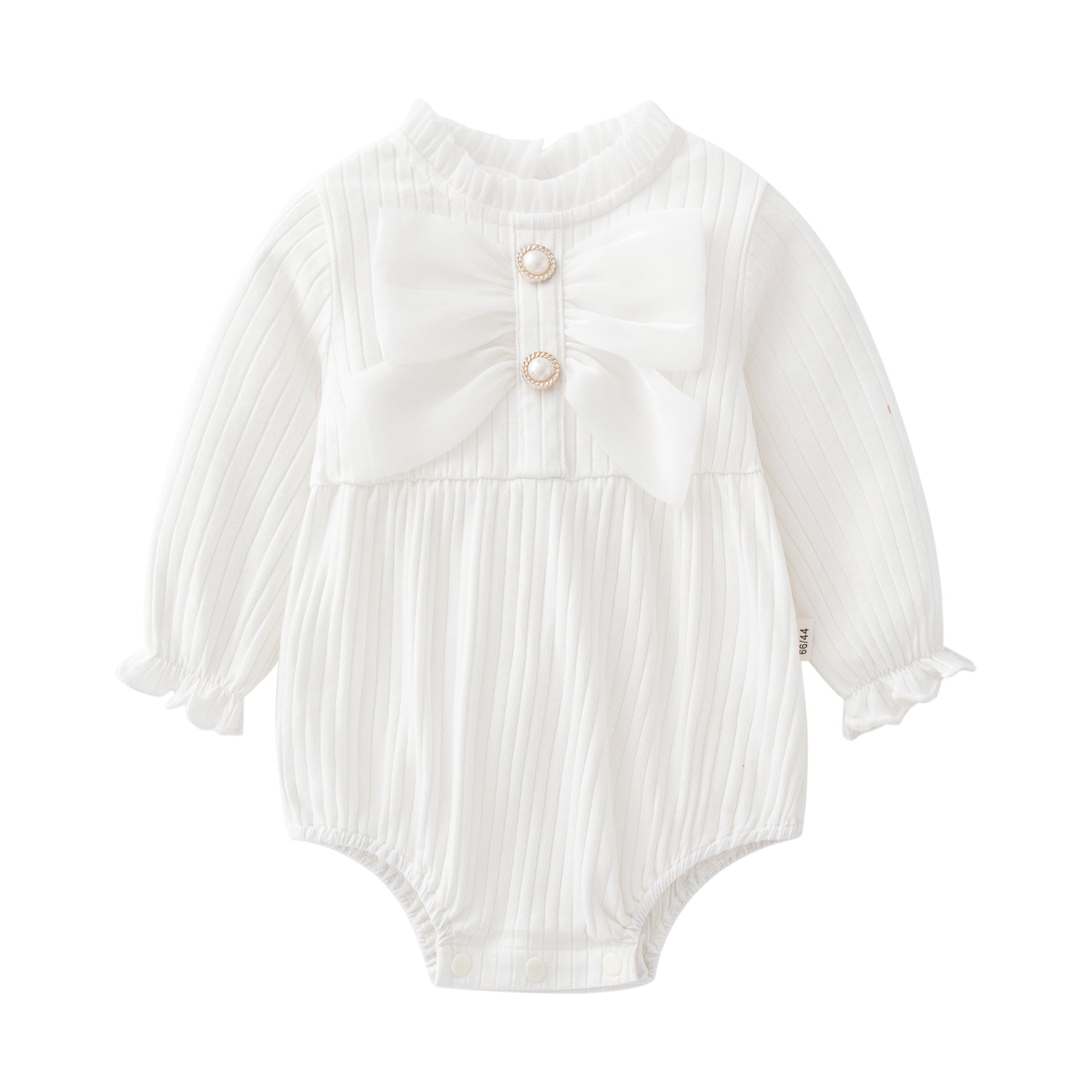Baby girl wearing a solid color onesie with a big bow design, showcasing comfort and style.
