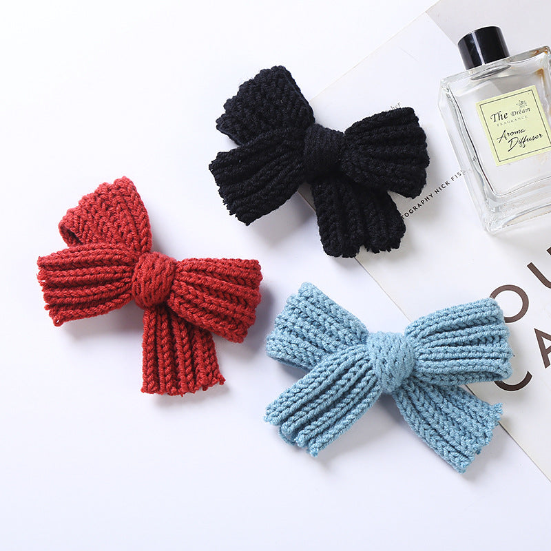 A colorful collection of handmade big knitted bow hairpins for baby girls, showcasing various colors like black, red, blue, and more.