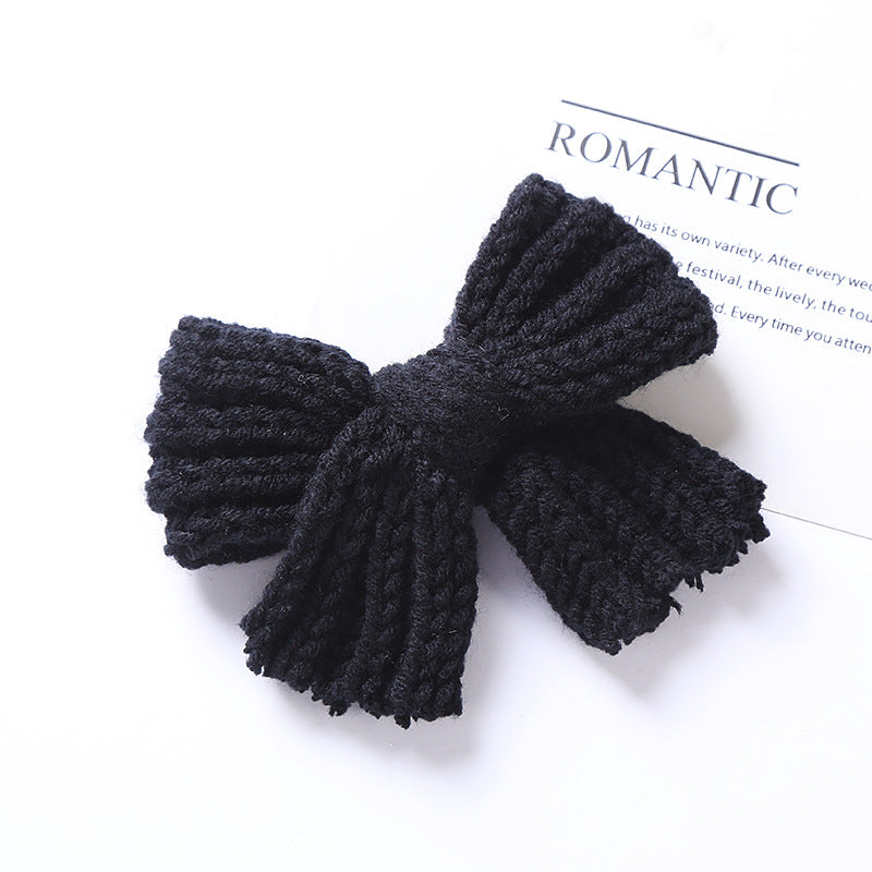 A colorful collection of handmade big knitted bow hairpins for baby girls, showcasing various colors like black, red, blue, and more.
