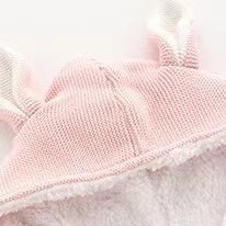 A cozy knitted cardigan for babies featuring a solid color design with bunny ears, available in pink and navy blue, perfect for chilly weather.