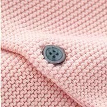 A cozy knitted cardigan for babies featuring a solid color design with bunny ears, available in pink and navy blue, perfect for chilly weather.