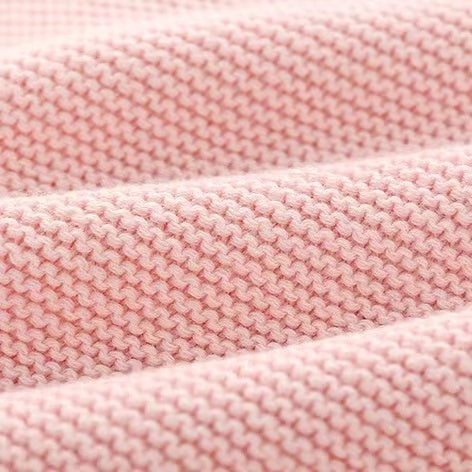 A cozy knitted cardigan for babies featuring a solid color design with bunny ears, available in pink and navy blue, perfect for chilly weather.