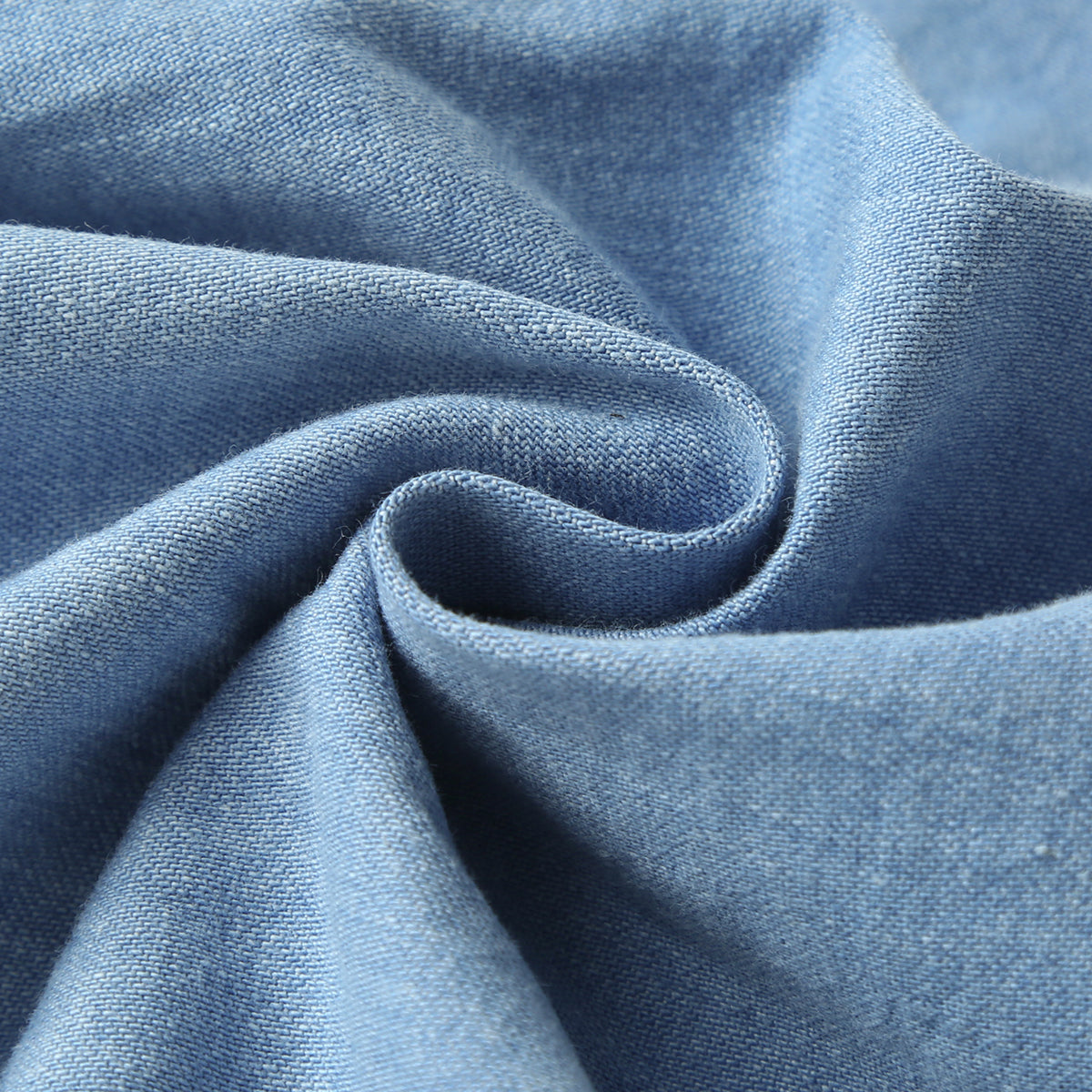 Baby wearing a solid color button front denim shirt and shorts set in blue, perfect for summer outings.