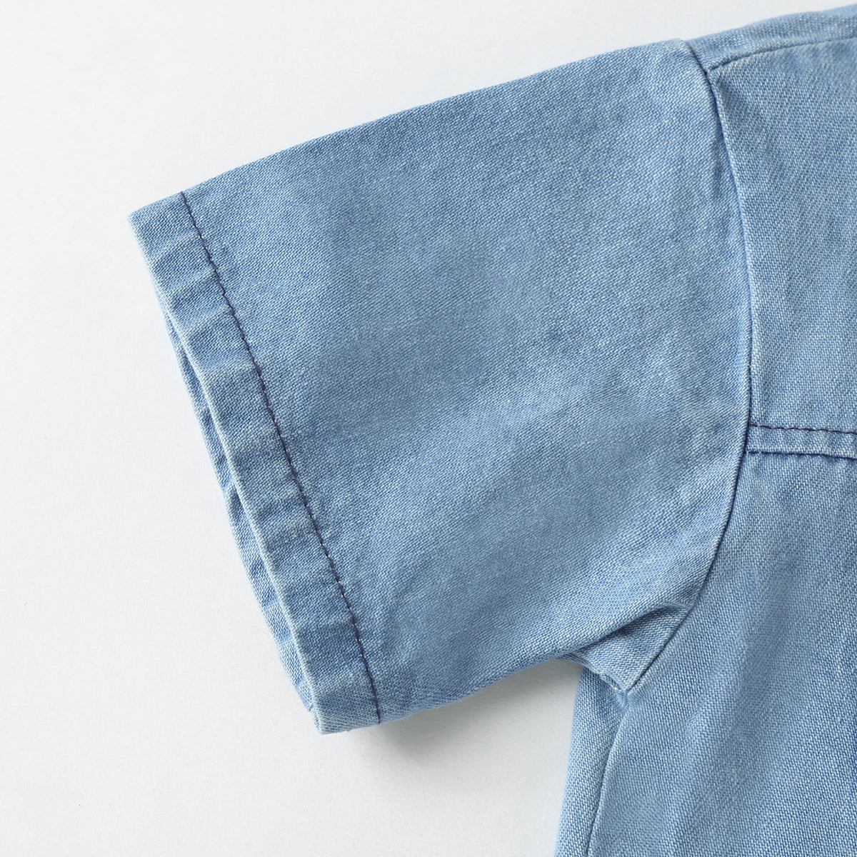 Baby wearing a solid color button front denim shirt and shorts set in blue, perfect for summer outings.