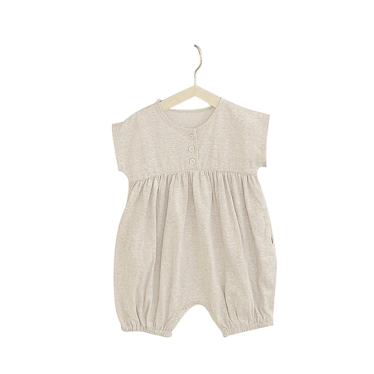 A baby wearing a solid color casual short sleeve romper in apricot, showcasing comfort and style.