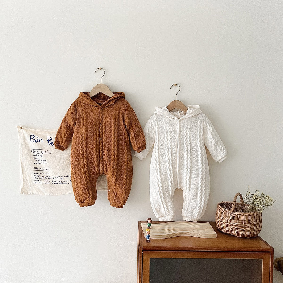 A cozy baby romper featuring a solid crochet-knitted pattern in white and brown, perfect for both baby girls and boys.