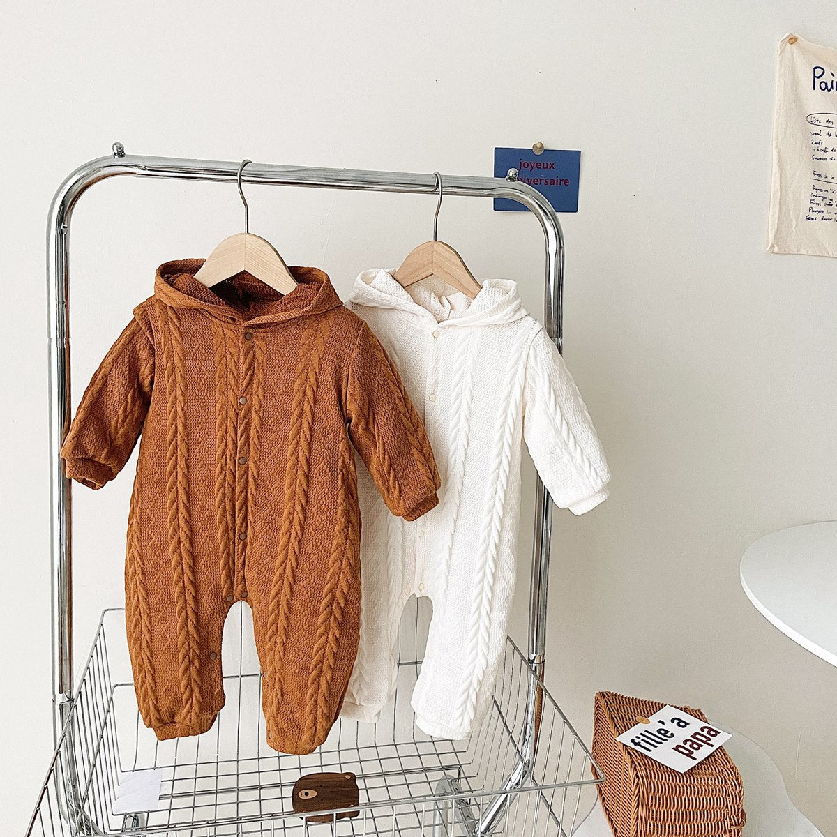 A cozy baby romper featuring a solid crochet-knitted pattern in white and brown, perfect for both baby girls and boys.