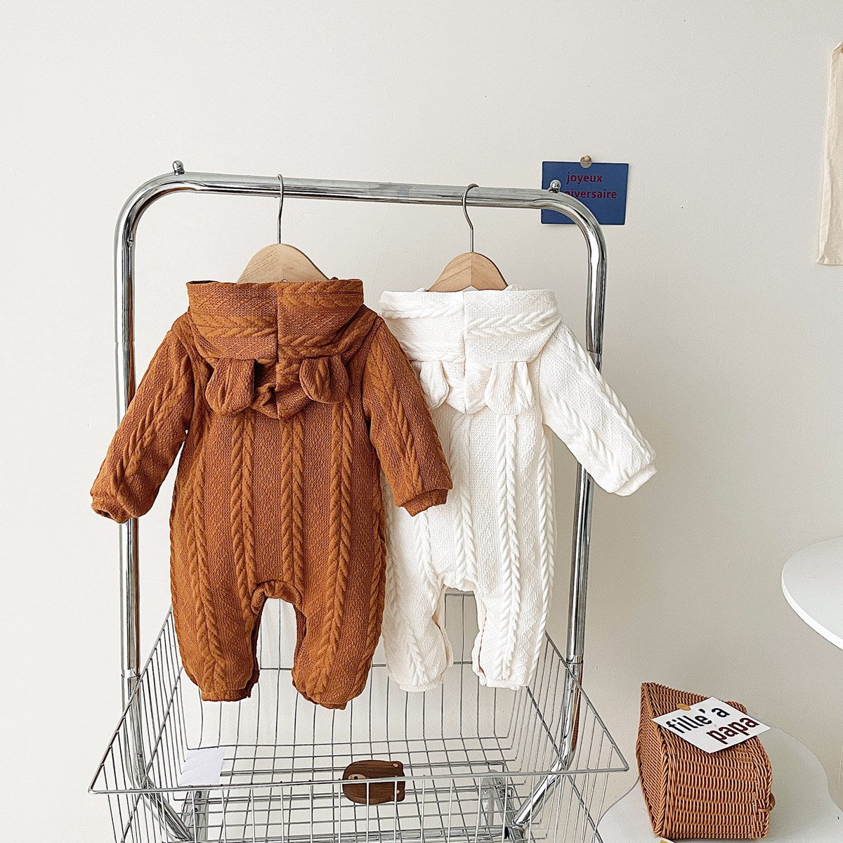 A cozy baby romper featuring a solid crochet-knitted pattern in white and brown, perfect for both baby girls and boys.