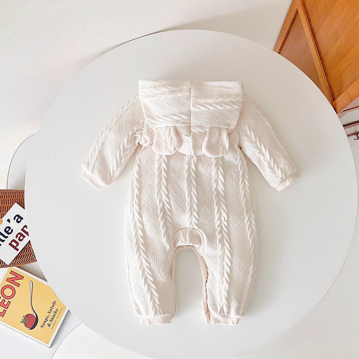 A cozy baby romper featuring a solid crochet-knitted pattern in white and brown, perfect for both baby girls and boys.