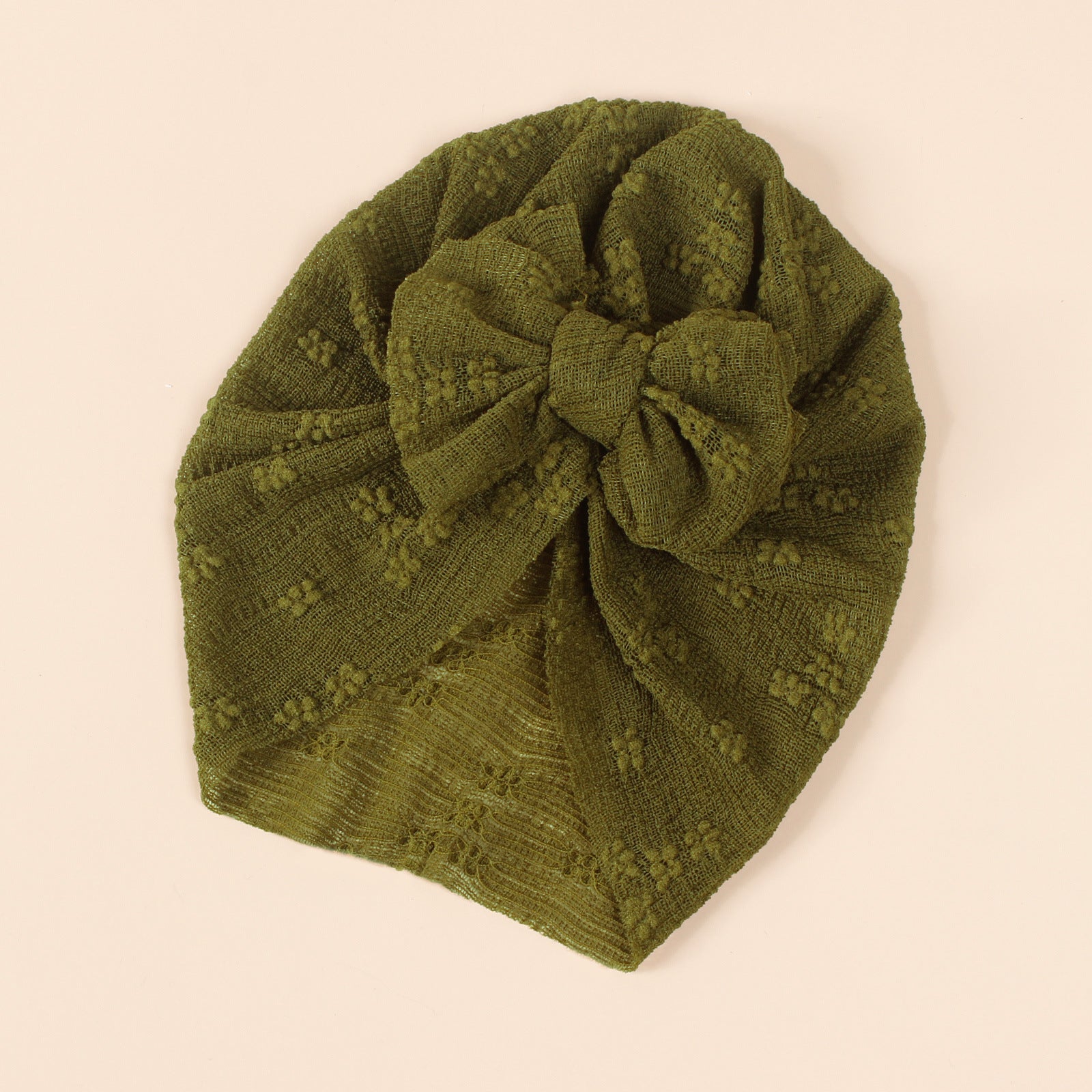 A collection of baby hats in solid colors including white, pink, blue, green, and beige, showcasing their elastic fit and breathable cotton material.