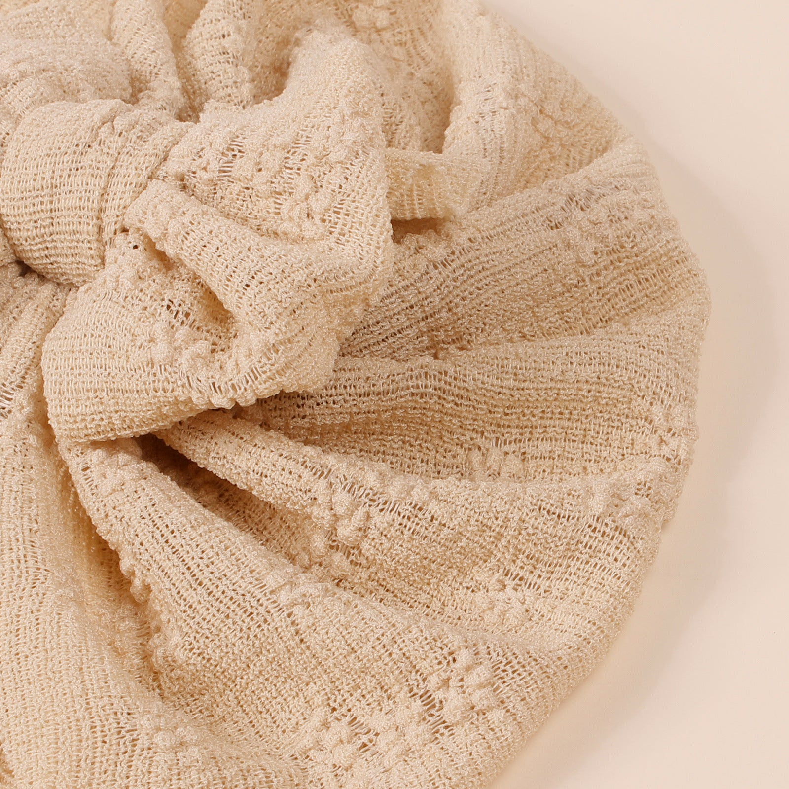 A collection of baby hats in solid colors including white, pink, blue, green, and beige, showcasing their elastic fit and breathable cotton material.