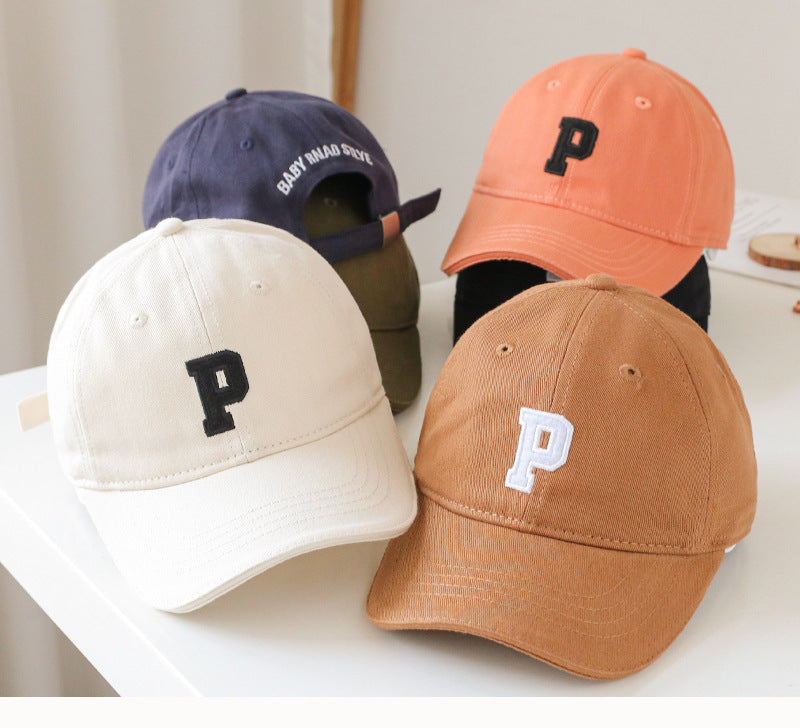 Baby wearing a solid color embroidered baseball hat, showcasing its stylish design and sun protection features.