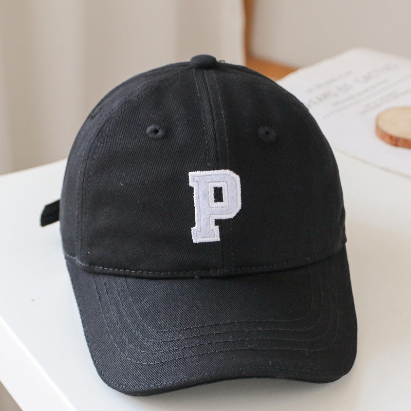 Baby wearing a solid color embroidered baseball hat, showcasing its stylish design and sun protection features.