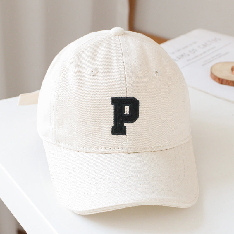 Baby wearing a solid color embroidered baseball hat, showcasing its stylish design and sun protection features.