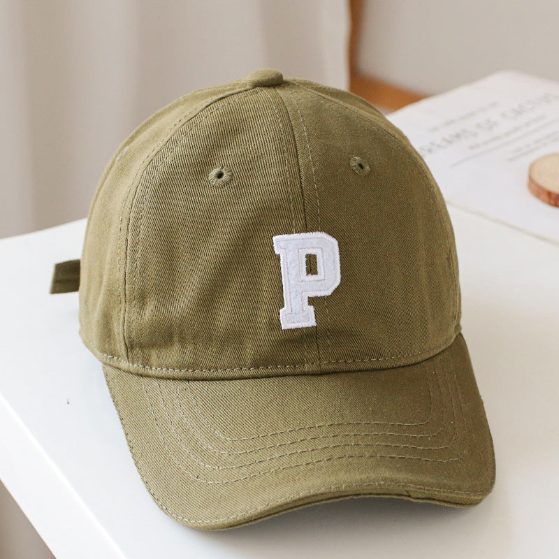 Baby wearing a solid color embroidered baseball hat, showcasing its stylish design and sun protection features.