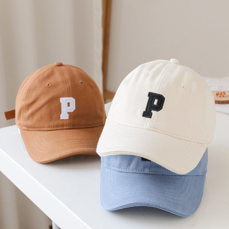 Baby wearing a solid color embroidered baseball hat, showcasing its stylish design and sun protection features.