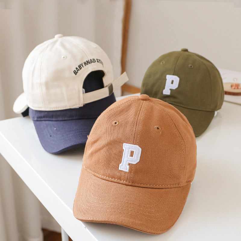 Baby wearing a solid color embroidered baseball hat, showcasing its stylish design and sun protection features.