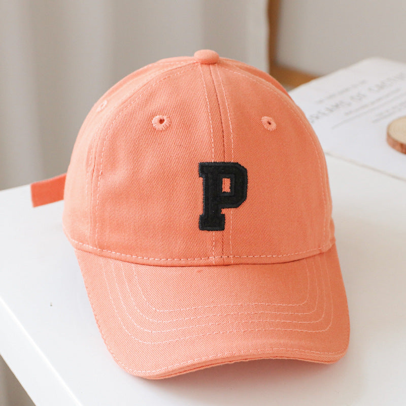 Baby wearing a solid color embroidered baseball hat, showcasing its stylish design and sun protection features.