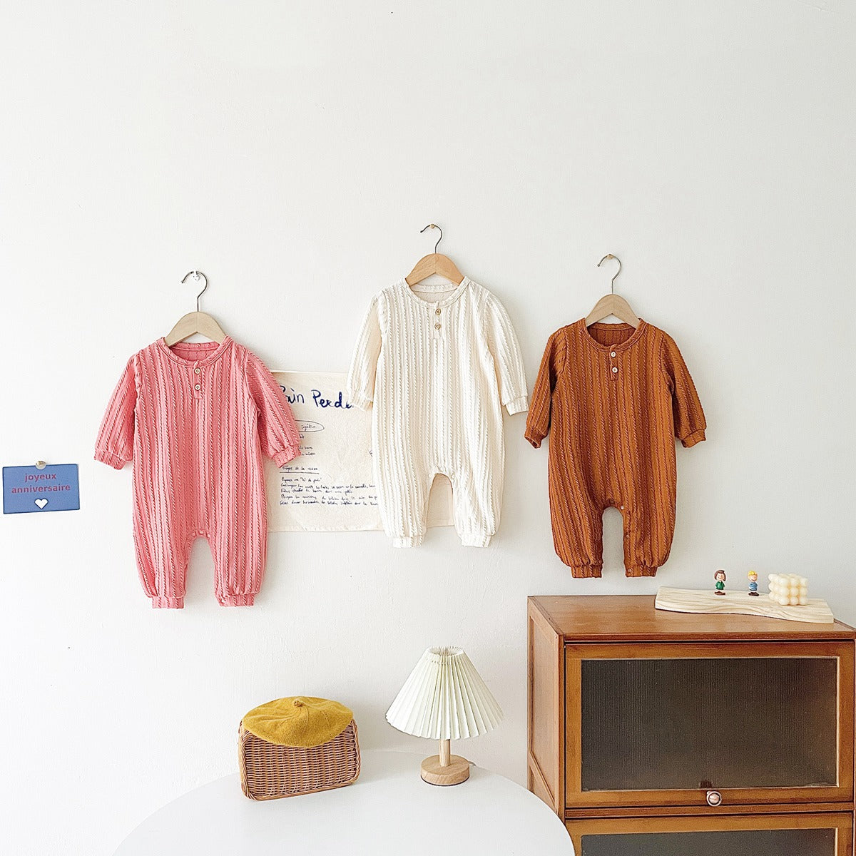 Baby Solid Color Long Sleeve Soft Cotton Romper in pink, apricot, and brown, showcasing its simple style and soft fabric.