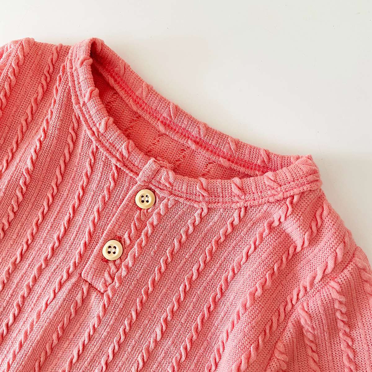 Baby Solid Color Long Sleeve Soft Cotton Romper in pink, apricot, and brown, showcasing its simple style and soft fabric.