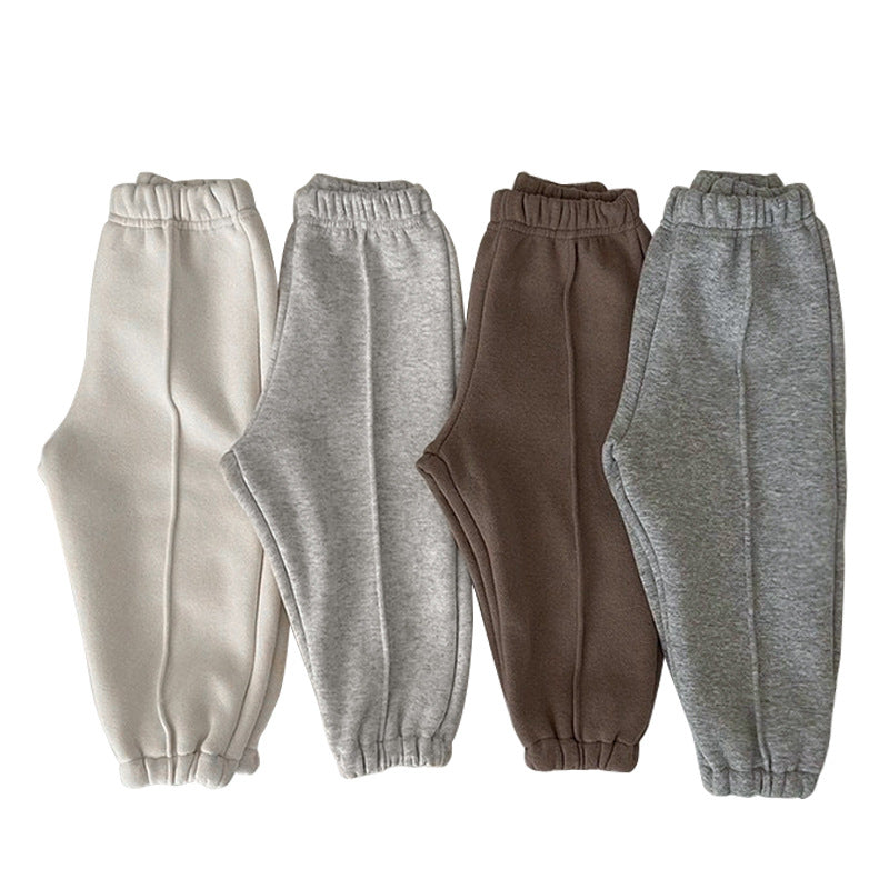 A pair of baby sweatpants in solid colors, showcasing soft fleece material, perfect for autumn wear.