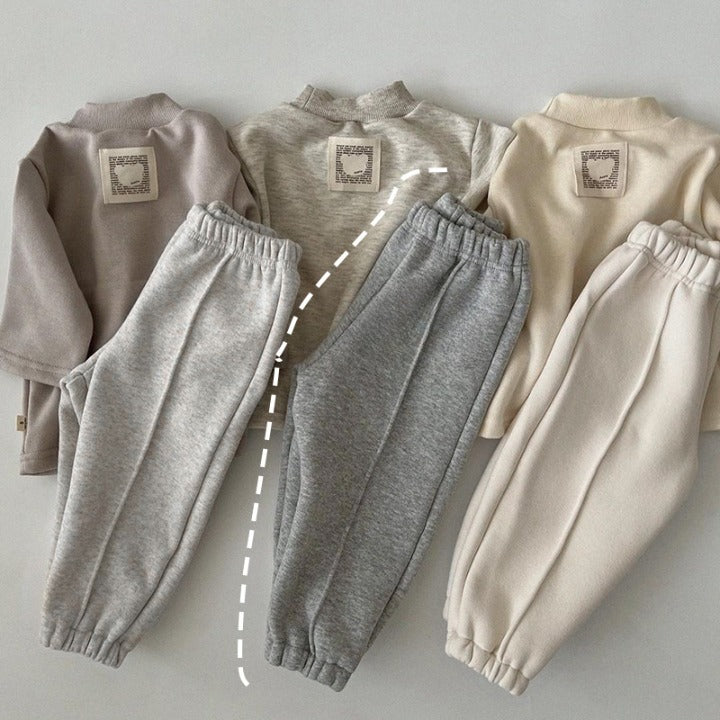 A pair of baby sweatpants in solid colors, showcasing soft fleece material, perfect for autumn wear.