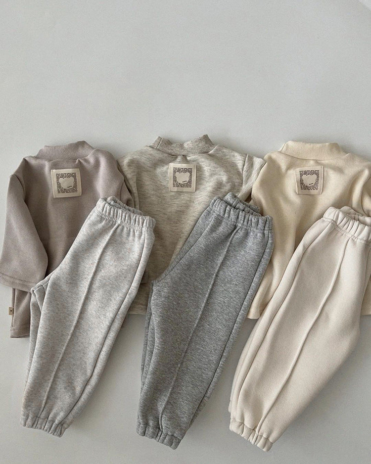 A pair of baby sweatpants in solid colors, showcasing soft fleece material, perfect for autumn wear.