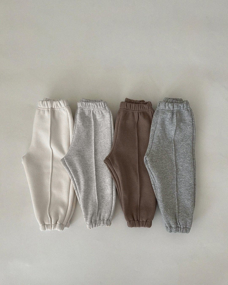 A pair of baby sweatpants in solid colors, showcasing soft fleece material, perfect for autumn wear.
