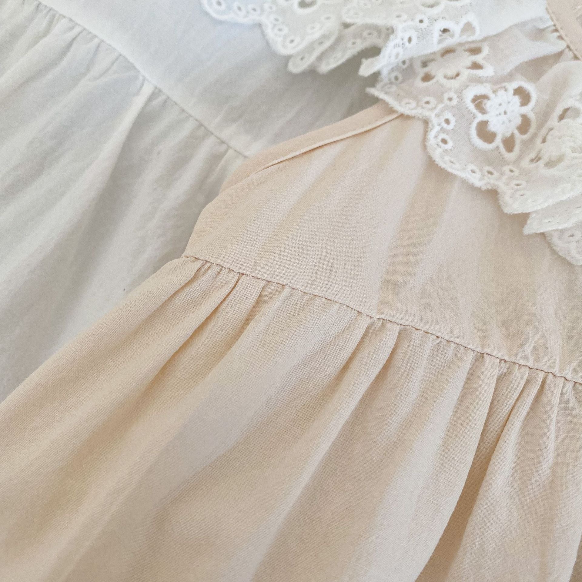 Baby Solid Color Mesh Doll Neck Sleeveless Onesies in white and brown, showcasing soft cotton fabric and stylish doll neck design.