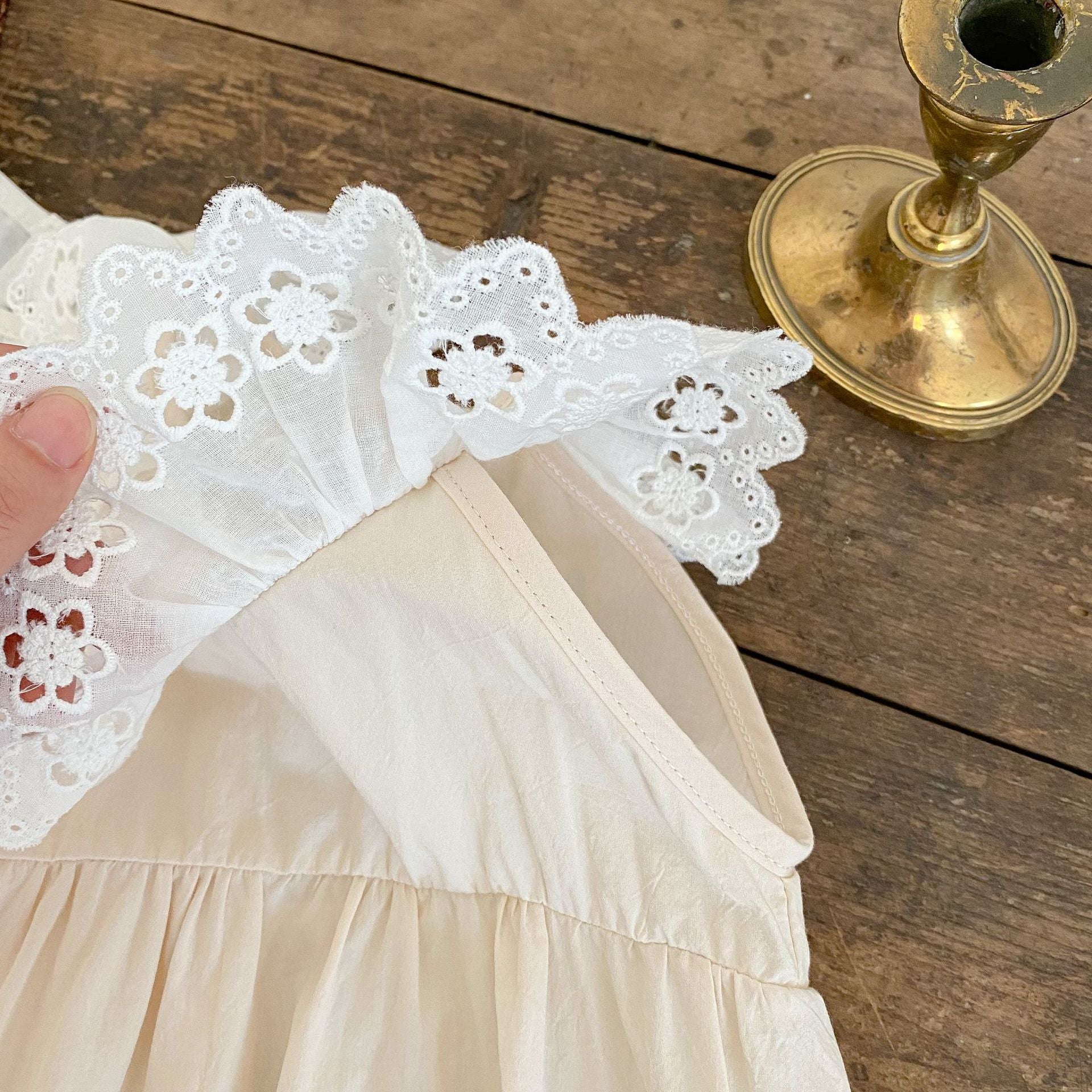 Baby Solid Color Mesh Doll Neck Sleeveless Onesies in white and brown, showcasing soft cotton fabric and stylish doll neck design.