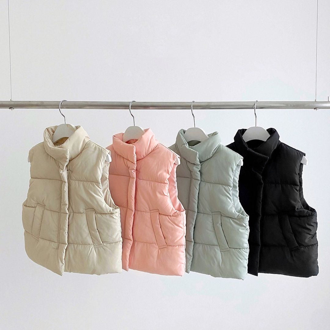 Baby Solid Color Quilted Thickened Vest Coat in Black, Pink, Blue, and Apricot colors, showcasing its stylish design and thickened material.