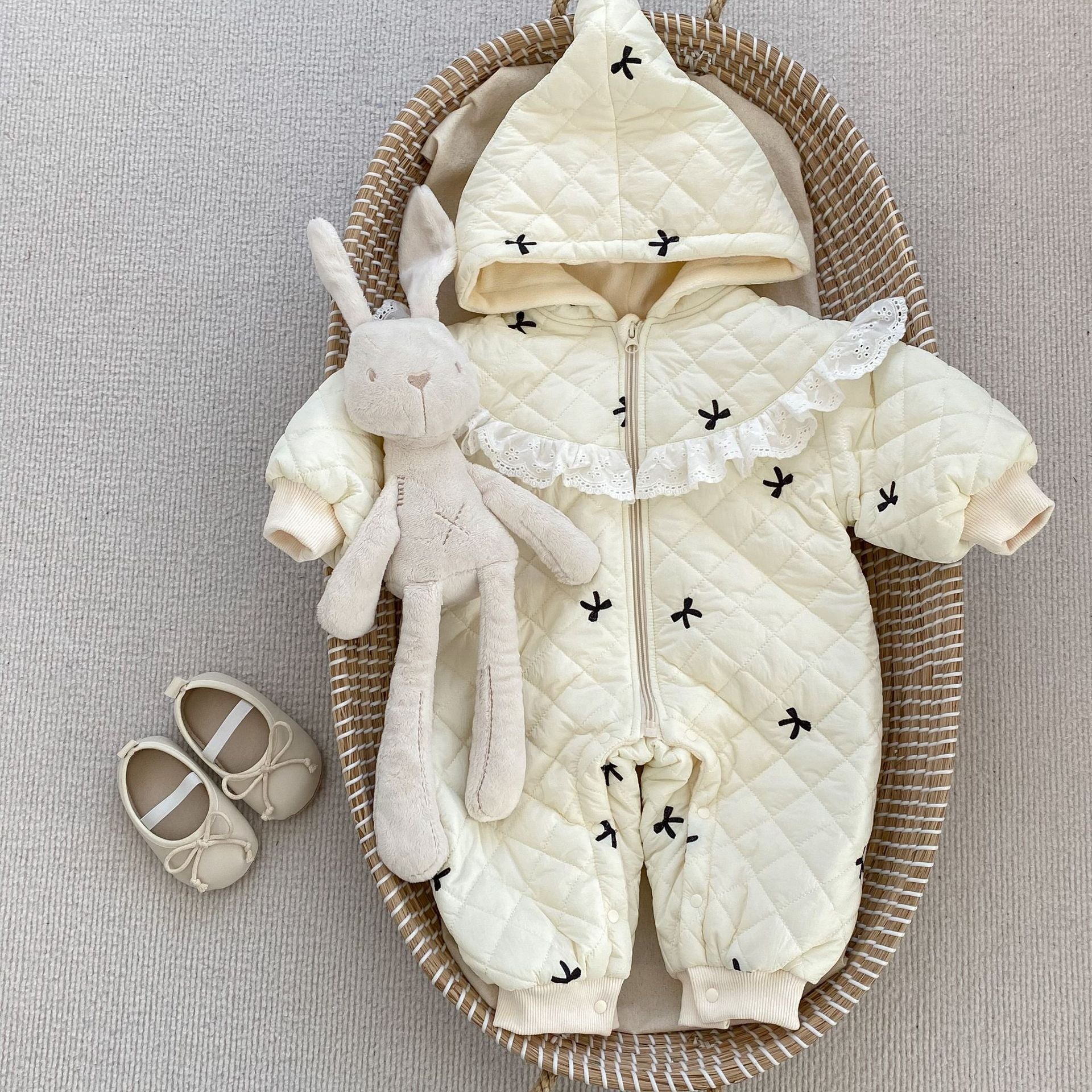Baby toddler girl wearing a beige long sleeve outfit with bowknot design, perfect for winter.