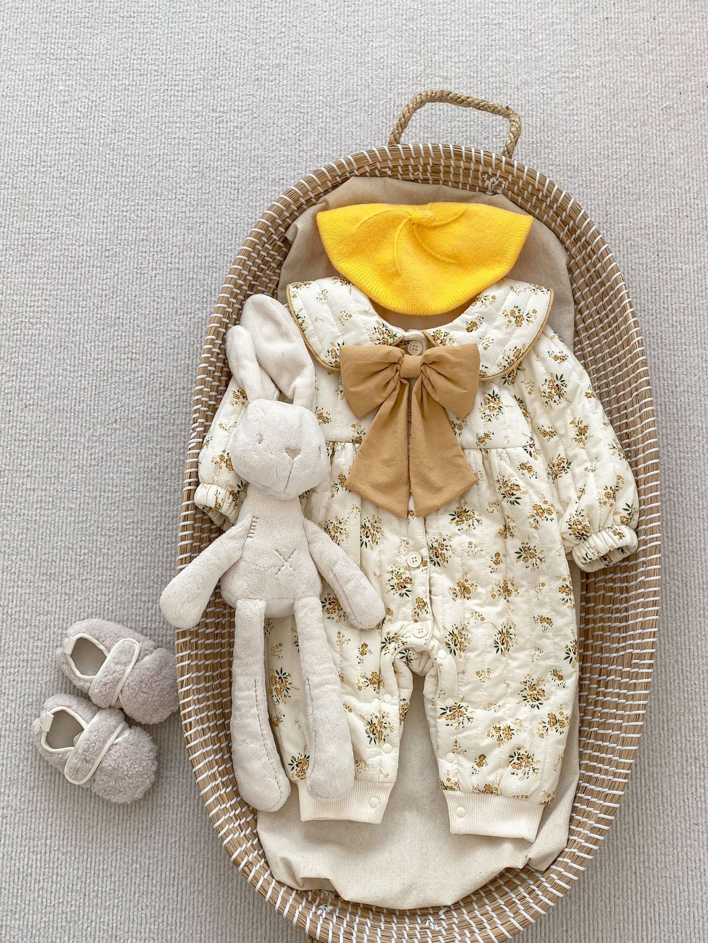 Baby toddler girl wearing a beige fleece floral print outfit with a big bow-knot and long sleeves, perfect for winter.