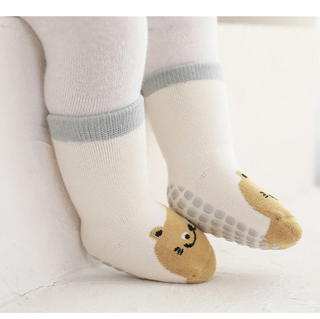 A pair of baby unisex breathable thermal socks featuring cartoon patchwork design in various colors, ideal for toddlers.
