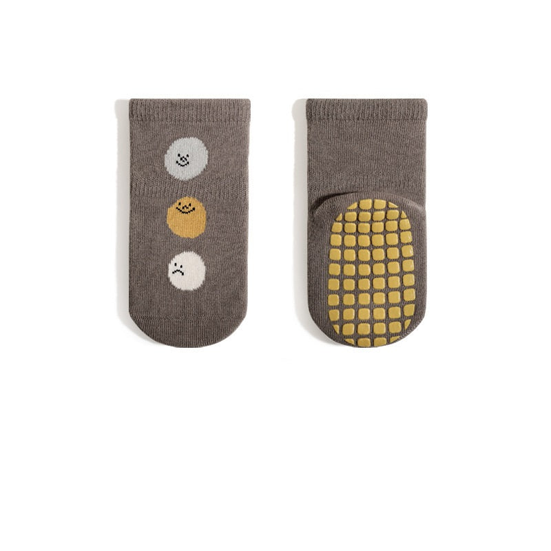 A pair of baby unisex breathable thermal socks featuring cartoon patchwork design in various colors, ideal for toddlers.