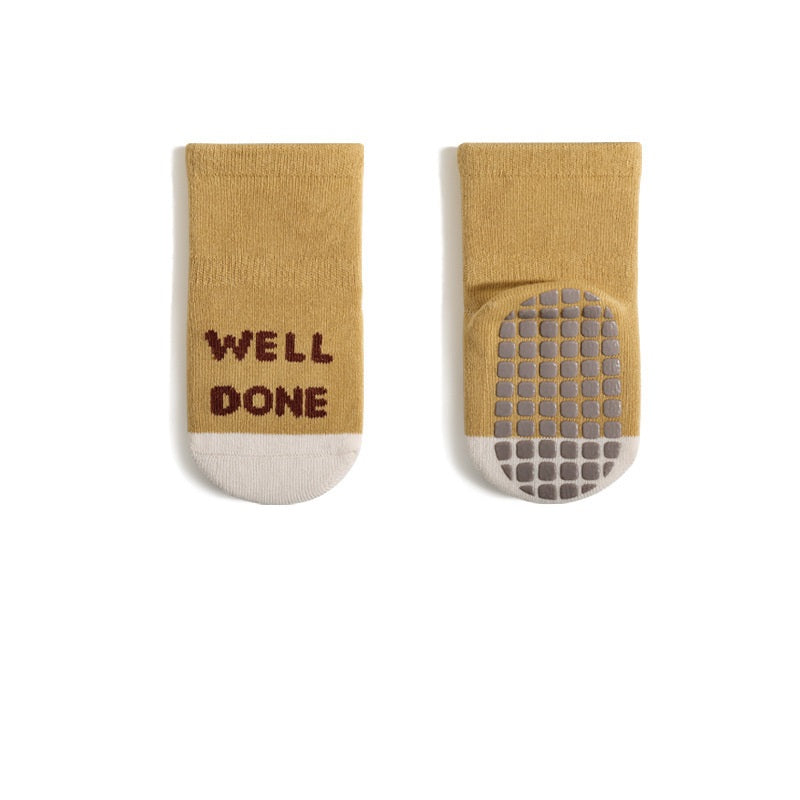 A pair of baby unisex breathable thermal socks featuring cartoon patchwork design in various colors, ideal for toddlers.