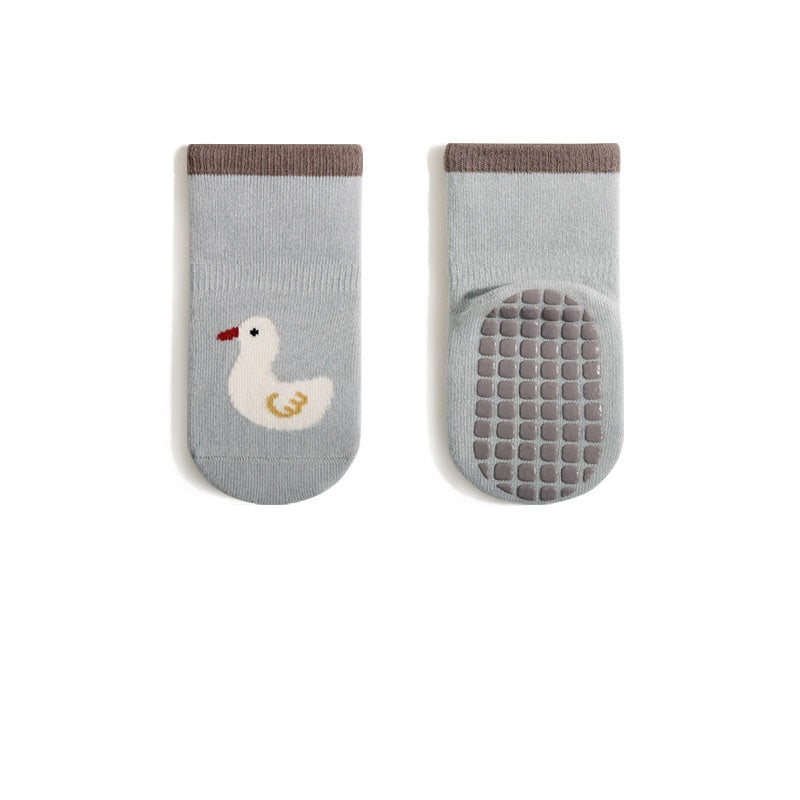 A pair of baby unisex breathable thermal socks featuring cartoon patchwork design in various colors, ideal for toddlers.