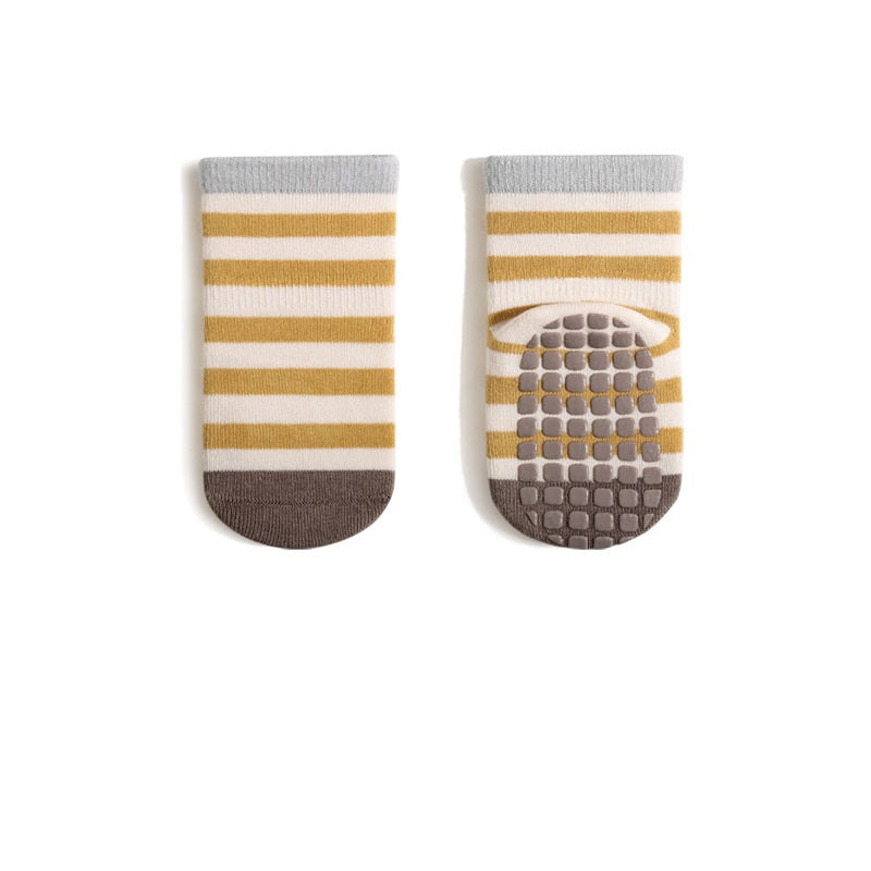 A pair of baby unisex breathable thermal socks featuring cartoon patchwork design in various colors, ideal for toddlers.