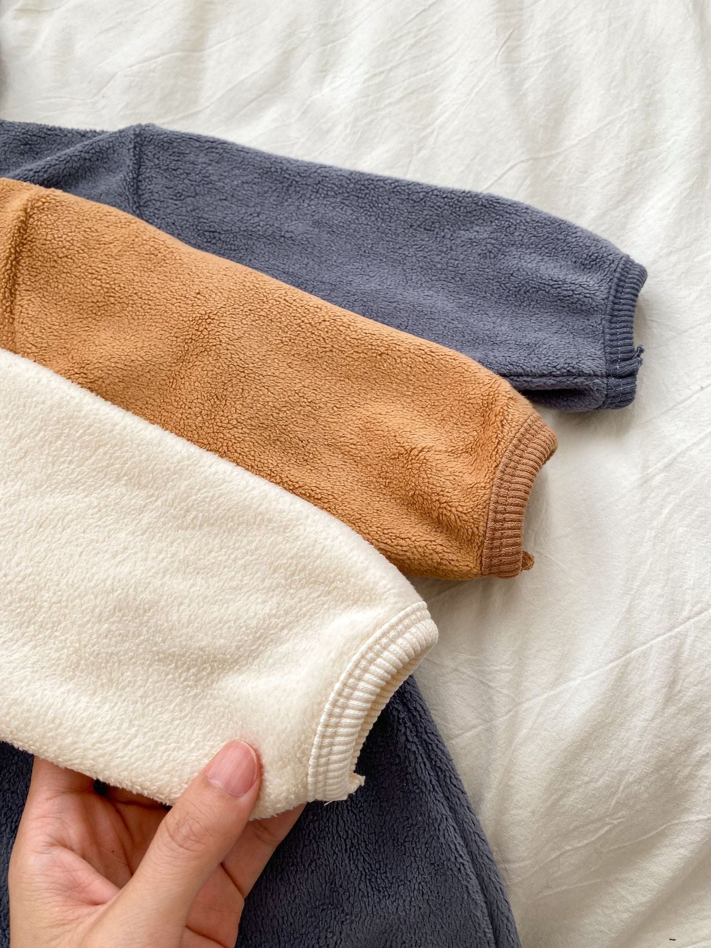 Baby unisex long sleeve romper featuring a cute bear head design, accompanied by a matching hat, available in navy blue, apricot, and brown.