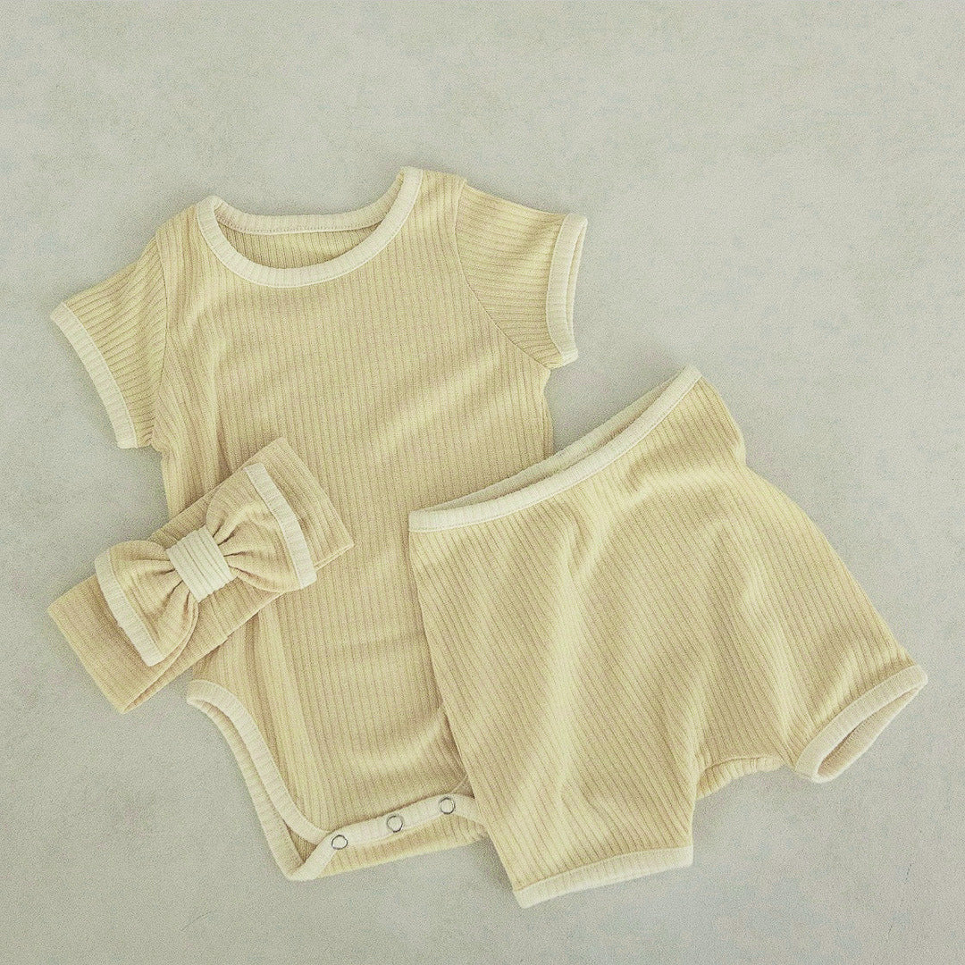 Baby unisex solid color comfy cotton onesies and shorts sets in white, pink, yellow, and apricot, perfect for summer wear.